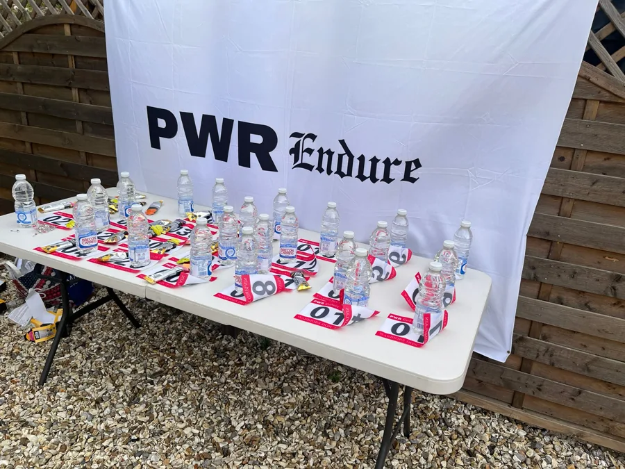 Race medals arranged beneath the original PWR banner